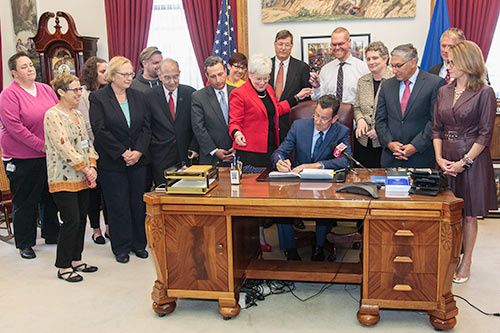 Photo of Governor Malloy signing the conversion therapy bill.